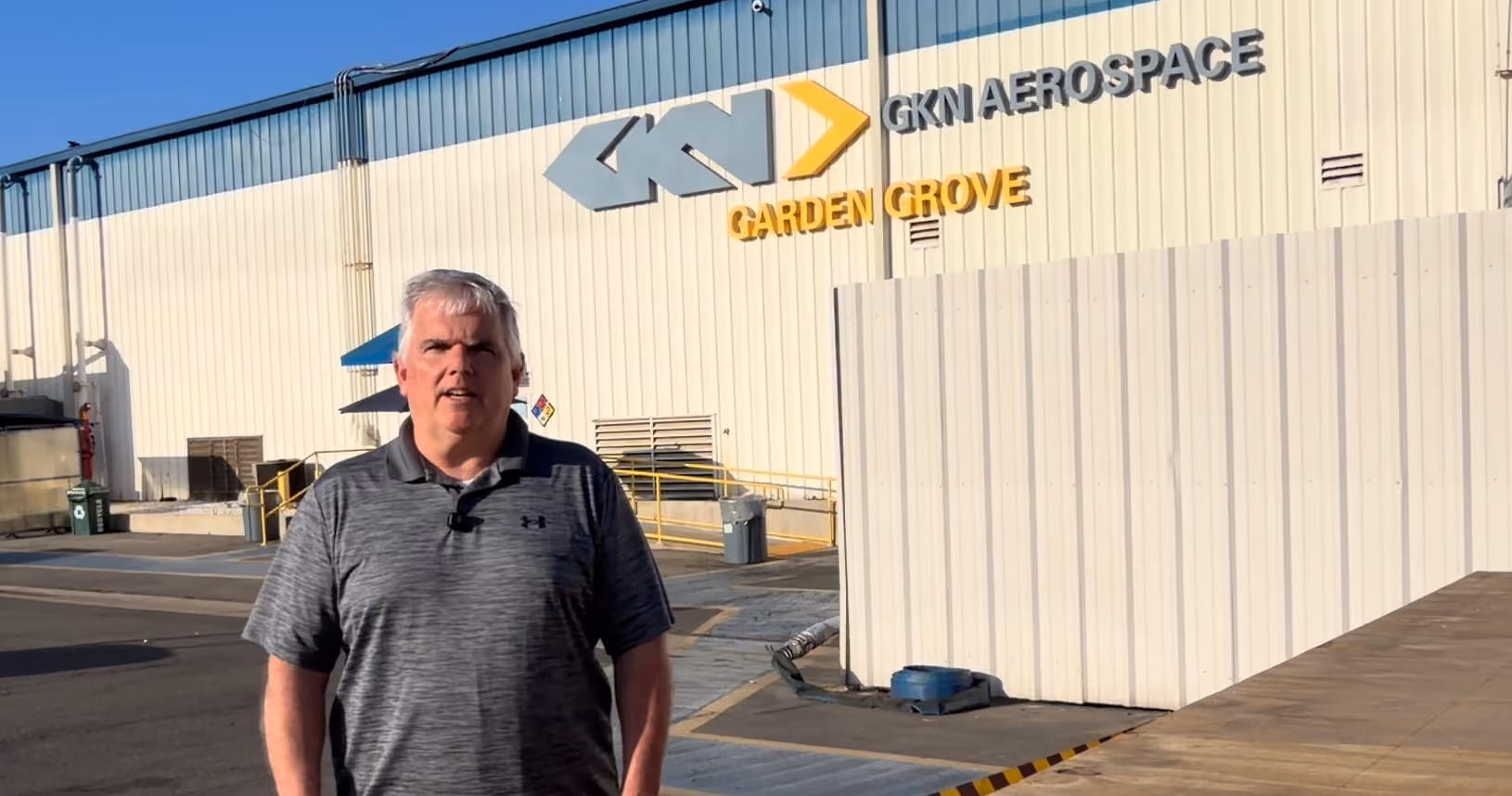 Person standing outside GKN Aerospace Garden Grove building.